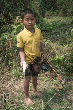 Village kid proud of his catch, near Muang Ngoi, Laos