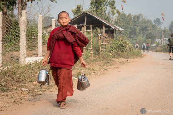 Monk child proudly bringing back water, Hsipaw, Myanmar