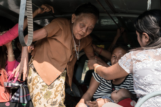 Old blind lady, coming down of my jam-packed pickup, Mawlamyine, Myanmar