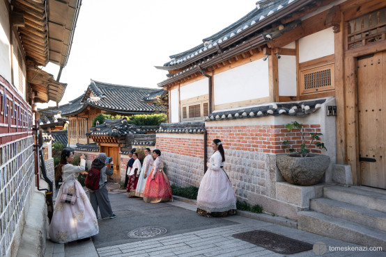 Koreans and tourists dress up in traditional outfits to wander the streets of Bukchon Hanok Village, Seoul