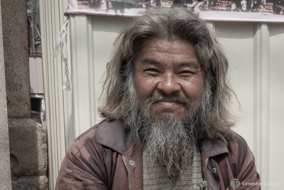 Old man sitting near Tainan Grand Mazu Temple. When I approached him to take this picture, he was holding a plastic bowl containing coins and various objects. I thought he was in need of food or money, but he greeted me with a smile, shook my hand, and continued wishing me a good day.